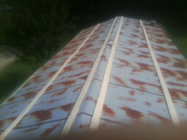 Rusted metal roof panels with new wood purlins before replacement — Storm Damage Roof Repair in Hanahan by Roofing Brothers